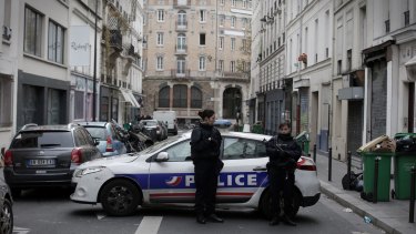 Police guard the crime scene near the La Belle Equipe cafe in Paris, France on Saturday.