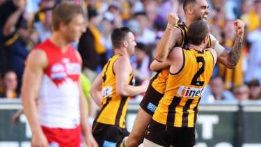 The story of the day: Jarryd Roughead lifts Shaun Burgoyne as the Hawks celebrate another goal.