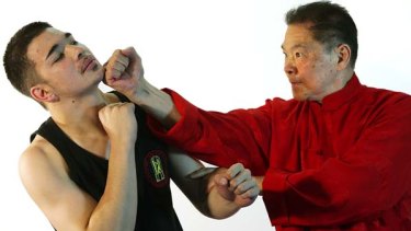 Grand master of Wing Chun Kung Fu, William Cheung, 70, spars with his son Andrew, 19.