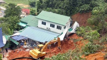 Rescuers work at the site of a landslide that hit an orphanage in Hulu Langat.