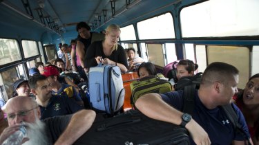 Mexican and international tourists board a bus to be transported to a shelter, bracing for the arrival of Hurricane Patricia, in Puerto Vallarta.