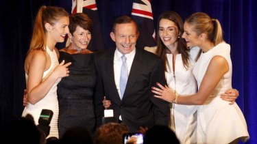 Under new management: Tony Abbott, surrounded by his family, claims victory.
