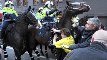 Mounted police advance on construction workers. <i>Photo: Justin McManus</i>