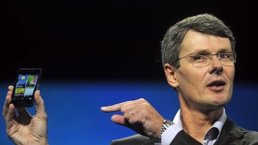 Research in Motion CEO Thorsten Heins holds up a prototype of the BlackBerry 10 smartphone at the BlackBerry World event in Orlando.