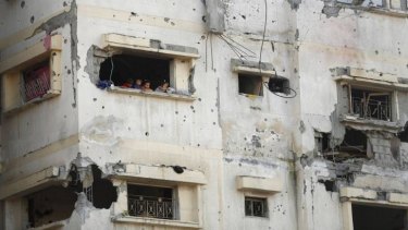 Palestinian children look out of their house in the east of Gaza City.