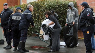 Four dead ... police take away evidence after the shooting at a Jewish school in Toulouse.