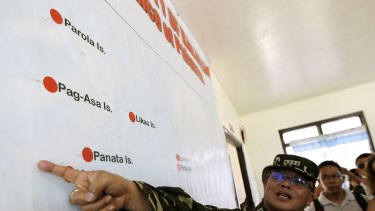 Philippine military chief General Gregorio Pio Catapang points to a map of islands in the Spratly group during a visit to Pag-asa Island in the Spratlys in the South China Sea.