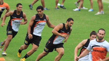 In line &#8230; Adam Blair, in yellow boots, goes through his paces yesterday at a Wests Tigers training session at Concord Oval behind Benji Marshall, who says he welcomes the former Storm hardman's commitment.