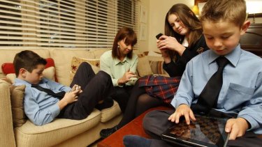 Wired: Gabrielle Jamison with her children Marcus, William, and Georgina with their electronic devices.