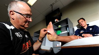 Stopping power: Ray Spiteri gives Blues midfielder David Ellard the treatment &#8230; with his Blister Proof patch.