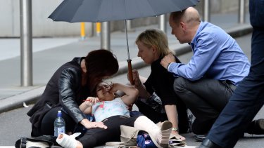Support is offered to a person injured in Bourke Street.