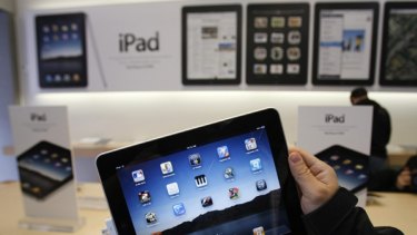A customer uses an Apple iPad on the first day of Apple iPad sales at an Apple store in San Francisco.