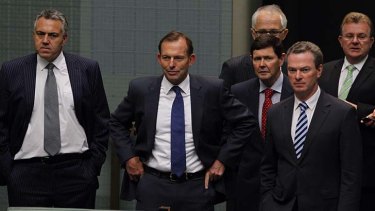 A step closer: Prime Minister Tony Abbott with members of the Coalition at Parliament House, Canberra, on Thursday.