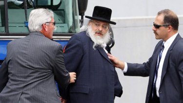 Under arrest ... a rabbi is taken into court.