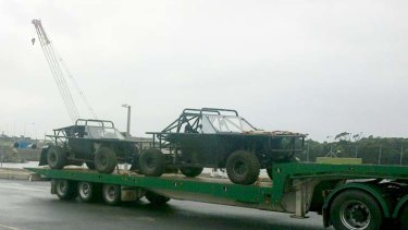 Vehicles for the new Mad Max film <i>Fury Road </i>on their way to storage.