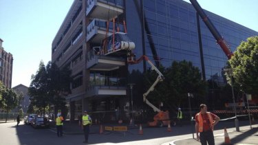 A crane is used to install a monorail carriage into Google's Pyrmont offices.