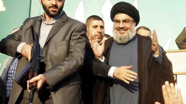 Lebanon's Hezbollah leader Sayyed Hassan Nasrallah greets his supporters at an anti-US protest.