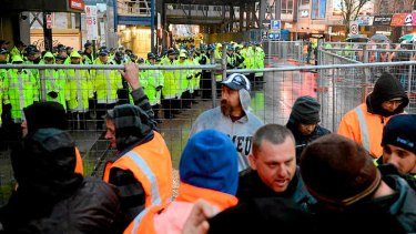 Union members and police face off at the troubled Grocon site on the corner of Swanston and Lonsdale Streets this morning.