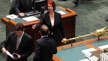 Prime Minister Julia Gillard enters Parliament for her first question time as Prime Minister and shakes hands with Opposition Leader Tony Abbott.