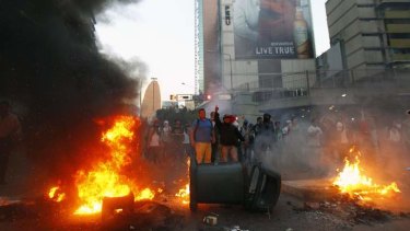 Fire on the streets: Demonstrators make a barricade of burning garbage in Caracas.