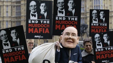 Hacked off &#8230; protesters, one in a James Murdoch mask, outside the Houses of Parliament in London.
