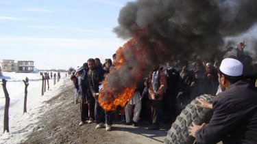 Afghans burn tyres during an anti-American demonstration over the burning of the Koran at a US military base south of Kabul.