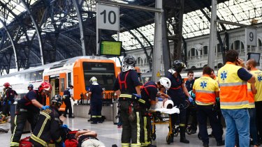 Emergency personnel tend to injured passengers at França station in Barcelona.
