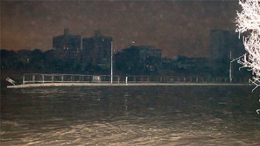 A large piece of the floating Riverwalk floats down the Brisbane River about 1am today. Photo: reader Conan Whitehouse