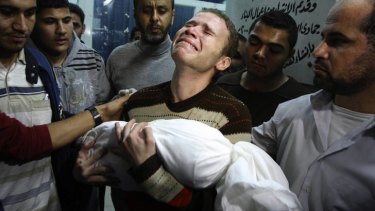 Jihad Masharawi weeps over the body of his 11-month old son, Omar, who died in an Israeli air strike on their family house in Gaza City on Wednesday.