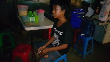 Sandi Saputra, a 13 year old smoker from Palembang. 