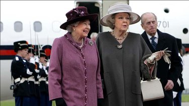 Royal tap on the shoulder ... Britain's Queen Elizabeth II, left, and Netherlands' Queen Beatrix, centre.