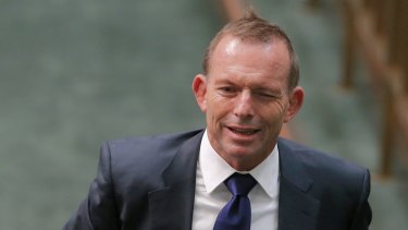 Former prime minister Tony Abbott winks as he departs Question Time.