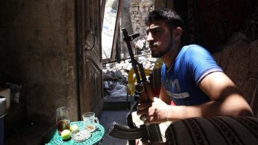 At a standstill: A Free Syrian Army fighter rests in al-Jdeideh neighbourhood in Aleppo.