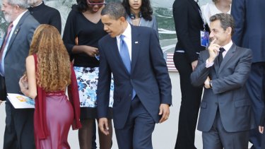 US President  Barack Obama and French President Nicolas Sarkozy appear to ogle a young woman.