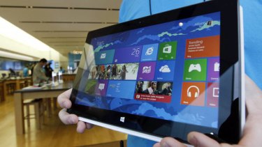 A US Microsoft store employee displays Microsoft's new Surface tablet.