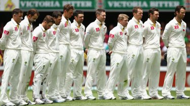 The Australian team observe a minute silence to commemorate Remembrance Day during day three of the First Test match between Australia and South Africa at The Gabba on November 11, 2012 in Brisbane, Australia.