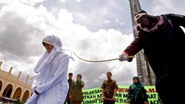 Sharia law ... A woman is caned in Aceh for selling food during Ramadan in October. A woman and a man will soon be caned publicly for adultery.
