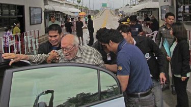 Under escort &#8230; Karl Joseph Kraus is escorted, against his will, across the Burmese border into the hands of Thai police.