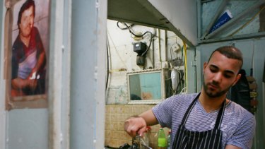 A Palestinian prepares hummus at a Jerusalem eatery.