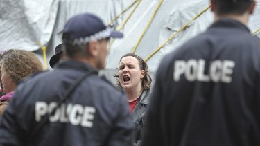 A protester shouts at police.