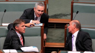 Independent MP Craig Thompson talks with Rob Oakeshott (left) and Tony Windsor (right) during question time at Parliament House.