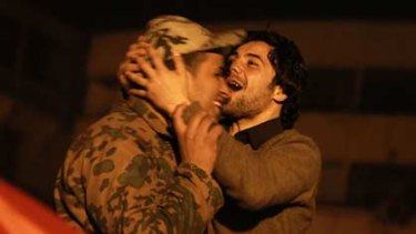 A protester kisses a soldier at Cairo's Tahrir Square after Mubarak's resignation.