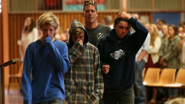 The three boys who pulled shark attack victim Zac Young from the water pictured at The Point Community Church: (from left) Shayden Schrader, Kurt Gillan and Lindsy Isaac are consoled by a friend.