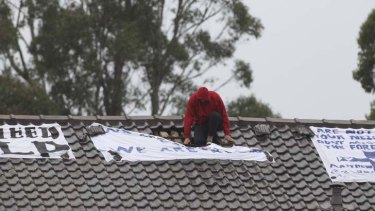 A protester on the roof of the detention centre at Villawood in 2011.