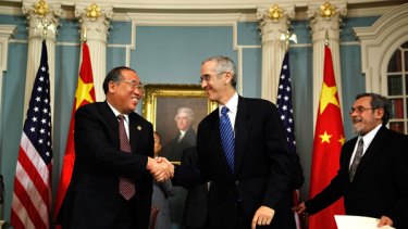 Vice-chairman of Chinese National Development Reform Commission Xie Zhenhua shakes hands with US Special Envoy for Climate Change Todd Stern after they signed a memorandum of understanding on Clean Energy and Climate Change in Washington, DC.