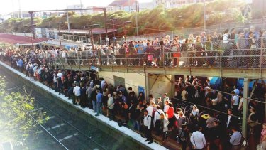 Commuters line up for buses at Moorabbin station.