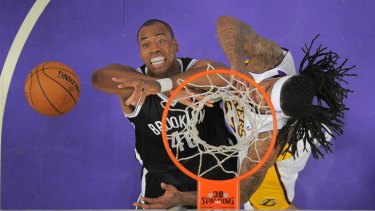 Brooklyn Nets centre Jason Collins, battles for a rebound with Los Angeles Lakers opponent Jordan Hill during the clash at the Staples Center.