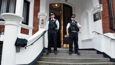 Metropolitan Police Officers wait outside the main door of the Ecuadorian embassy in London, where WikiLeaks founder Julian Assange is holed up.