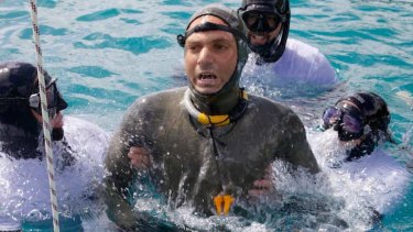 Nicholas Mevoli is helped after a free dive on Friday. On Sunday, he died after spending 3 minutes 38 seconds under water.
