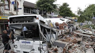 A bus crushed by falling building debris in Christchurch.